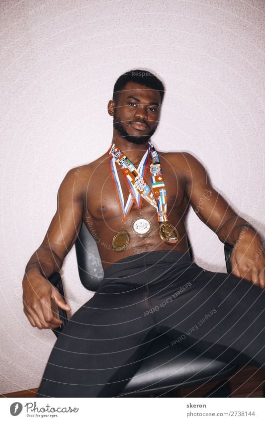 African athlete with medals on his chest Lifestyle Leisure and hobbies Sports Fitness Sports Training Track and Field Sportsperson Award ceremony Success