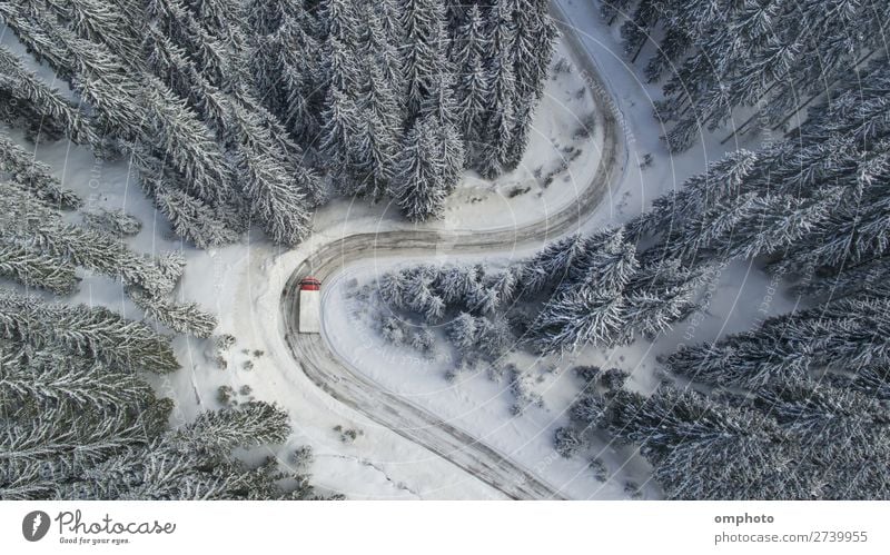 Aerial landscape with meandering snowy winter mountain road with a moving truck Winter Snow Mountain Nature Landscape Tree Forest Road traffic Vehicle Truck