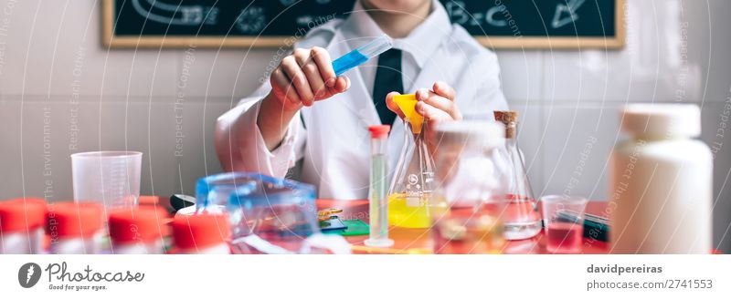 Serious little boy playing with chemical liquids Bottle Happy Playing Table Science & Research Child Classroom Blackboard Laboratory Internet Human being