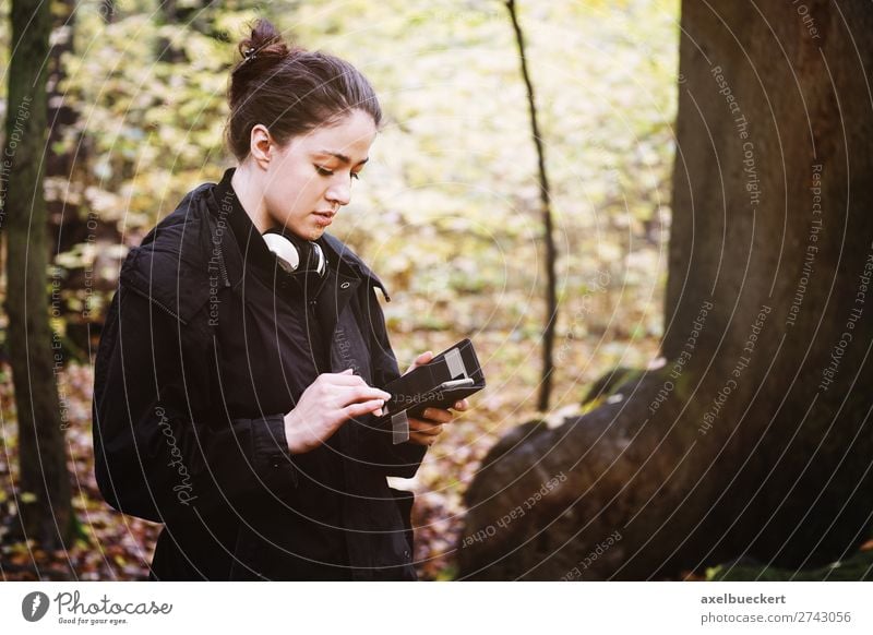 young woman uses smartphone in forest Lifestyle Leisure and hobbies Cellphone PDA Internet Human being Feminine Young woman Youth (Young adults) Woman Adults 1