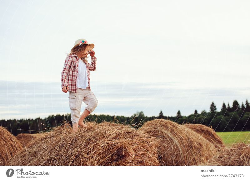 happy child girl in country style plaid shirt and hat Style Joy Relaxation Vacation & Travel Summer Child Infancy Nature Landscape Meadow Shirt Hat Smiling