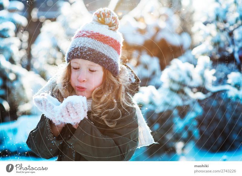 child girl playing with snow in winter garden or forest Joy Happy Playing Knit Vacation & Travel Winter Snow Garden Child Weather Forest Scarf Hat Drop Smiling