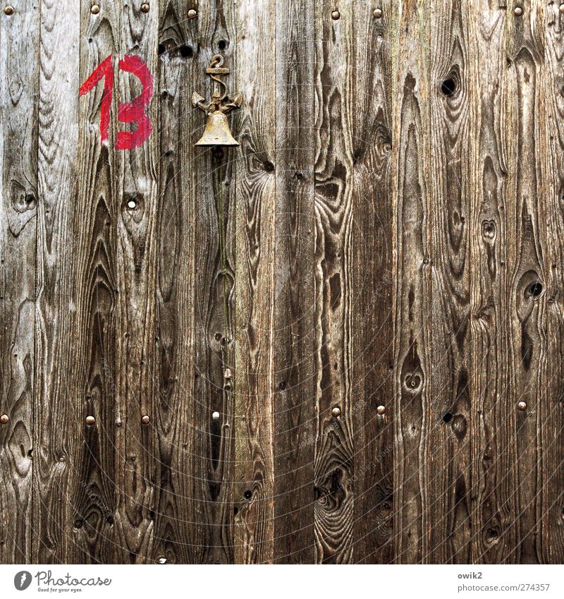 protest bell Door Wooden door Wood grain Bell Metal Sign Digits and numbers 13 Symbols and metaphors Hang Simple Small Above Brown Red Thrifty Whimsical chime