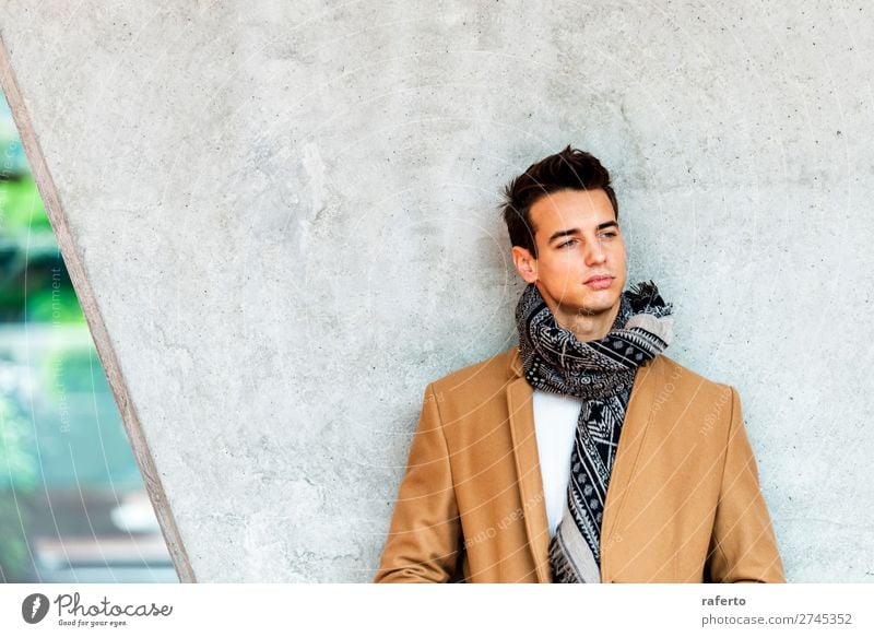 Young man wearing winter clothes in the street. - a Royalty Free