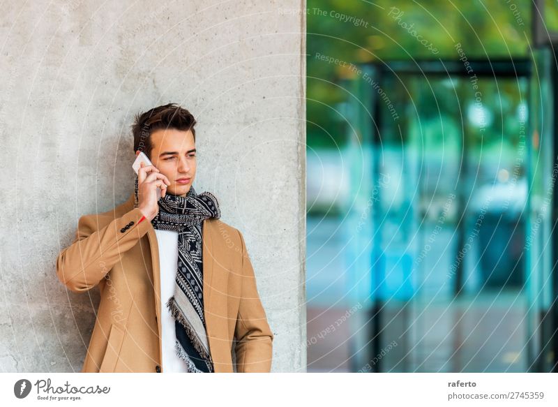 Young man wearing denim clothes using a mobile phone Lifestyle Elegant Style Beautiful Hair and hairstyles To talk Telephone PDA Masculine Youth (Young adults)