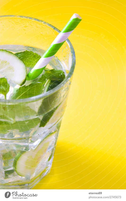 Mojito cocktail in glass on yellow background Cocktail Beverage Drinking Alcoholic drinks Refreshment Summer Lime Green Mint Juice Rum Cold Ice Ice cream Mixer