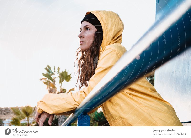 Young brunette woman on a lifeguard tower Lifestyle Relaxation Trip Freedom Sun Beach Winter Sports 30 - 45 years Adults Nature Horizon Coast Places Fashion