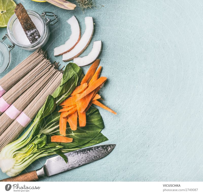 Asian food background. Traditional cooking ingredients for stir fry : noodles, vegetables and spices, top view, flat lay. Chinese or Thai cuisine. Vegan food. Healthy nutrition concept.