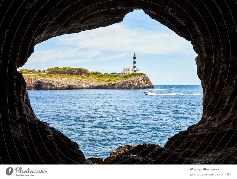 Portocolom Lighthouse seen from a cave, Mallorca. Vacation & Travel Tourism Trip Adventure Far-off places Freedom Sightseeing Cruise Expedition Summer