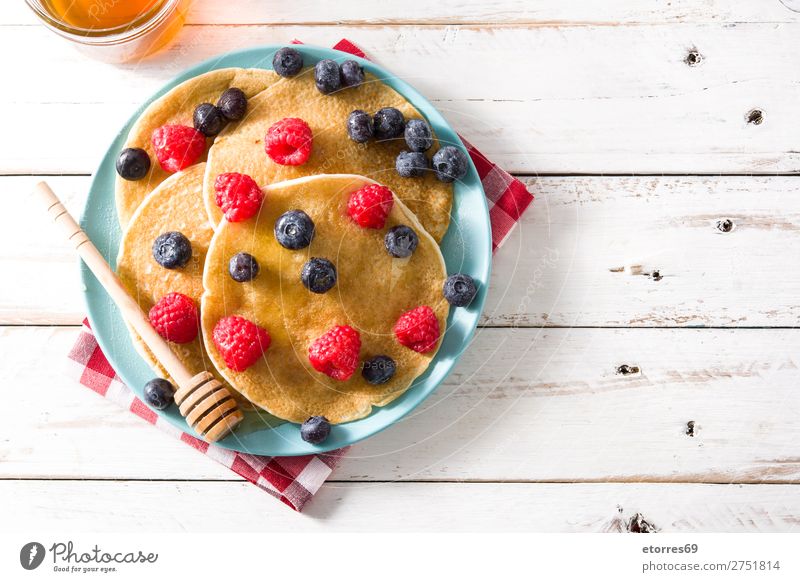 Pancakes with raspberries, blueberries and honey Sweet Dessert Breakfast Blueberry Raspberry Berries Red Baking Honey Food Dish Food photograph Plate isolated