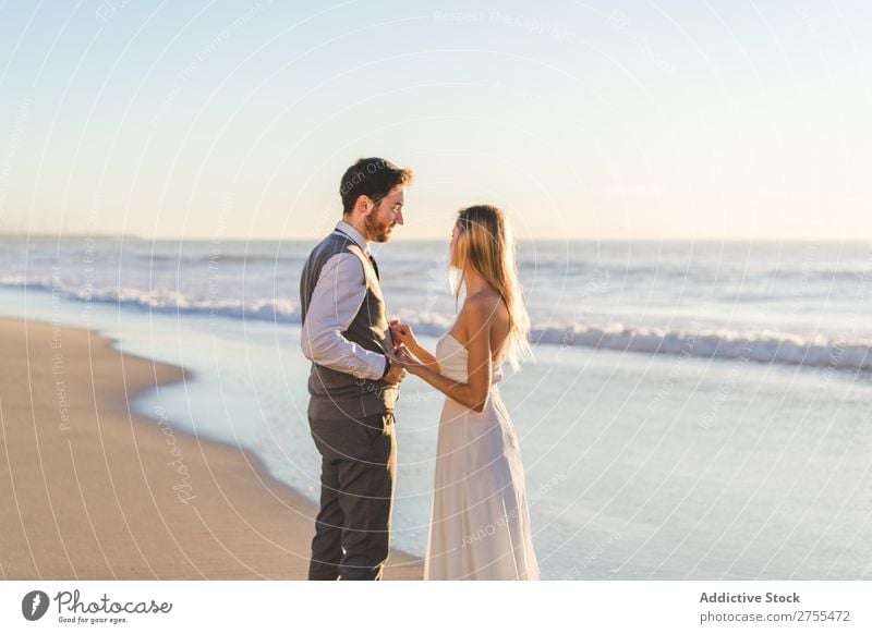 Tender kissing bridal couple in sunlight Couple Wedding Beach Sunlight Engagement Contentment valentine enjoyment in love seascape Stand Relationship Summer
