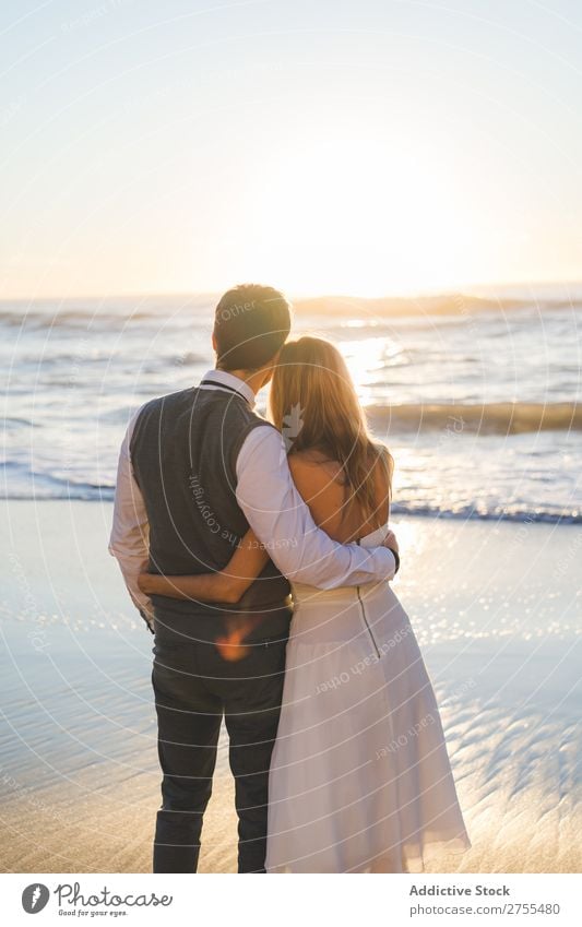 Embracing wedding couple in sunset light Couple Wedding Beach Sunlight enjoyment Stand embracing Happiness Love Beauty Photography Together Sunset romantic