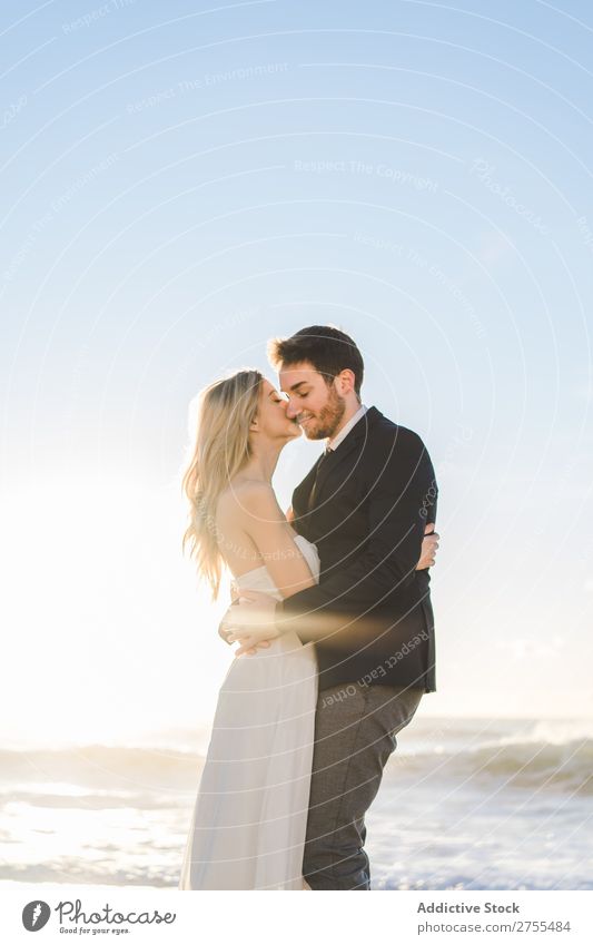 Tender kissing bridal couple in sunlight Couple Wedding Beach Sunlight embracing Engagement Contentment valentine enjoyment in love seascape Stand Relationship