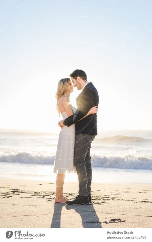 Tender kissing bridal couple in sunlight Couple Wedding Beach Sunlight embracing Engagement Contentment valentine enjoyment in love seascape Stand Relationship