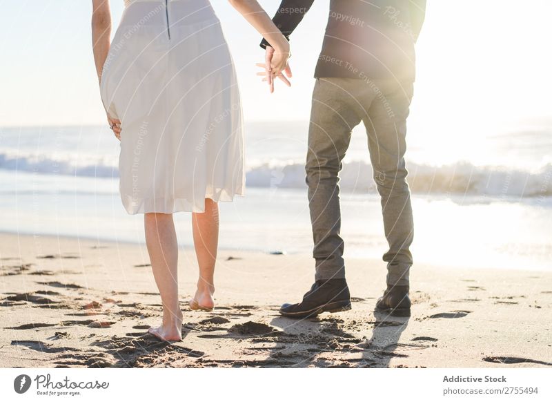 Crop bride and groom on sand Couple Groom Bride Sand Beach Stand Feet in love newlyweds Nature Coast Sunlight Relationship Beauty Photography Barefoot