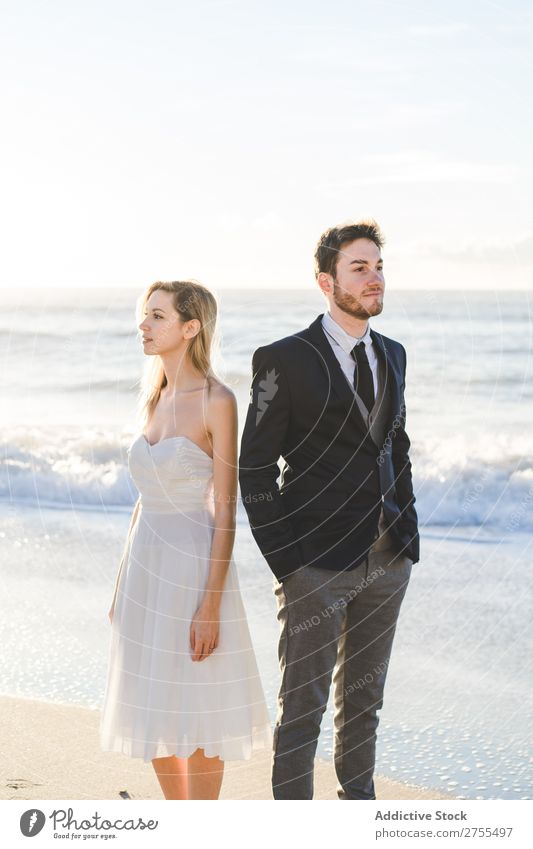 Bridal couple posing on sunny beach Couple Bride Groom Beach dreamers romantic back to back in love Youth (Young adults) Posture Love Together Happiness Style