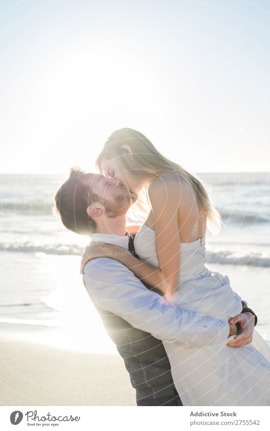 Wonderful bridal couple kissing on beach Couple Kissing Beach Wedding Carrying in love To enjoy amorous embracing Love seaside romantic Together Bride Groom