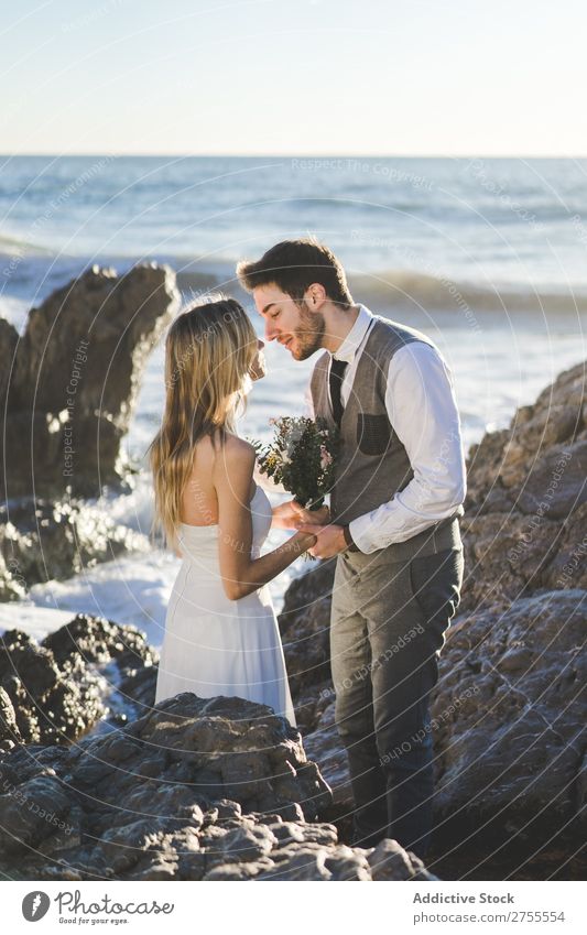 affectionate romantic wedding couple going to kiss on beach Stock Photo -  Alamy
