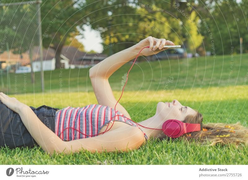 Girl with gadgets on lawn Woman Headphones Relaxation PDA Feminine Music Dream Flower Meadow Entertainment Student Park Summer Freedom Contentment Nature