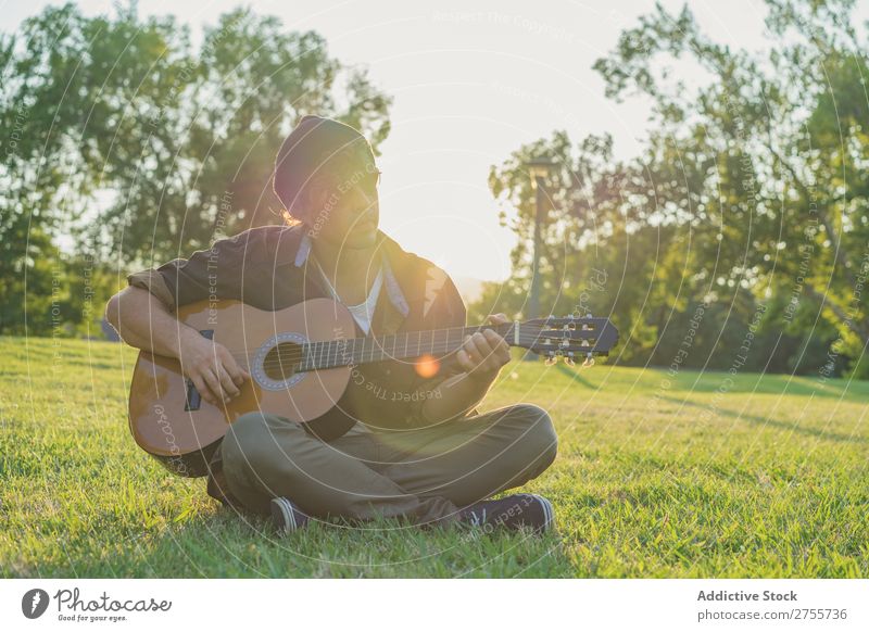 Man playing guitar on nature Park Guitar Summer Playing Landscape Hipster Musician Dream Nature Lifestyle romantic Vacation & Travel singing Easygoing