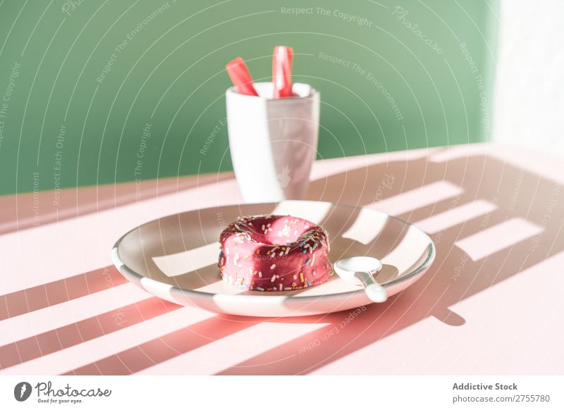 Colorful doughnut and drink in sunlight composition Donut Drinking Pink Delicious Sweet Dessert Stripe Baked goods Sunlight Confectionary Art Plate Table Shadow