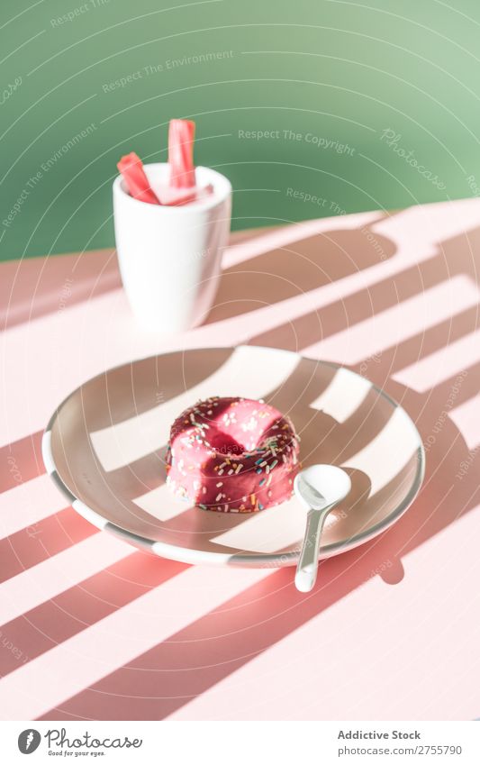 Colorful doughnut and drink in sunlight composition Donut Drinking Pink Delicious Sweet Dessert Stripe Baked goods Sunlight Confectionary Art Plate Table Shadow