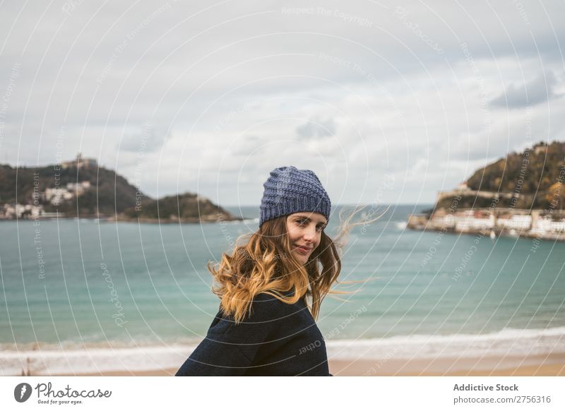 Attractive woman standing at ocean Woman Youth (Young adults) Coast Ocean pretty Hat Looking back at camera Nature Water Vacation & Travel Beach San Sebastián