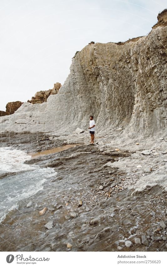 Man standing on rocky beach Tourist Cliff Ocean Rock Vacation & Travel Tourism Nature Landscape Coast Water Sun Freedom Stone Natural Lifestyle Beautiful