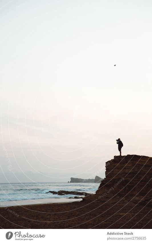 Unrecognizable man on coastal cliff Man Tourist Cliff Ocean Rock Vacation & Travel Tourism Nature Landscape Coast Water Sun Freedom Stone Natural Lifestyle