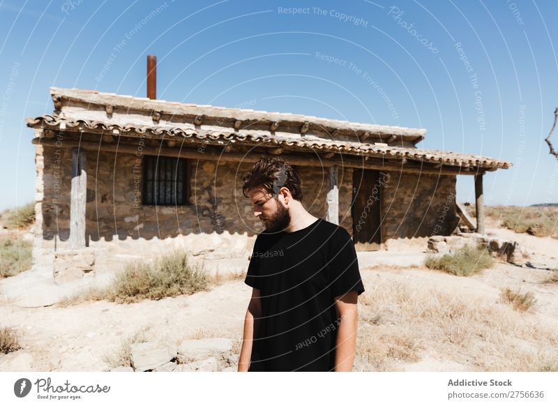 Man posing near abandoned house in the desert Desert Vacation & Travel Lifestyle Human being Adults Nature Adventure Trip Tourist Landscape