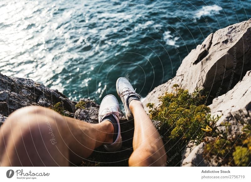 Man sitting on cliff Cliff Desert Vacation & Travel Legs Lifestyle Human being Adults Stone Rock Nature Adventure Freedom traveler Trip Tourist Hot Relaxation