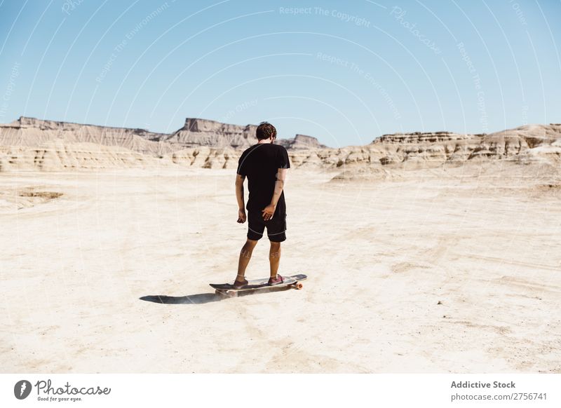Man riding skateboard in desert Skateboard Desert Vacation & Travel Lifestyle Human being Adults Nature Adventure Trip Tourist Sports Action Extreme Cliff Hill