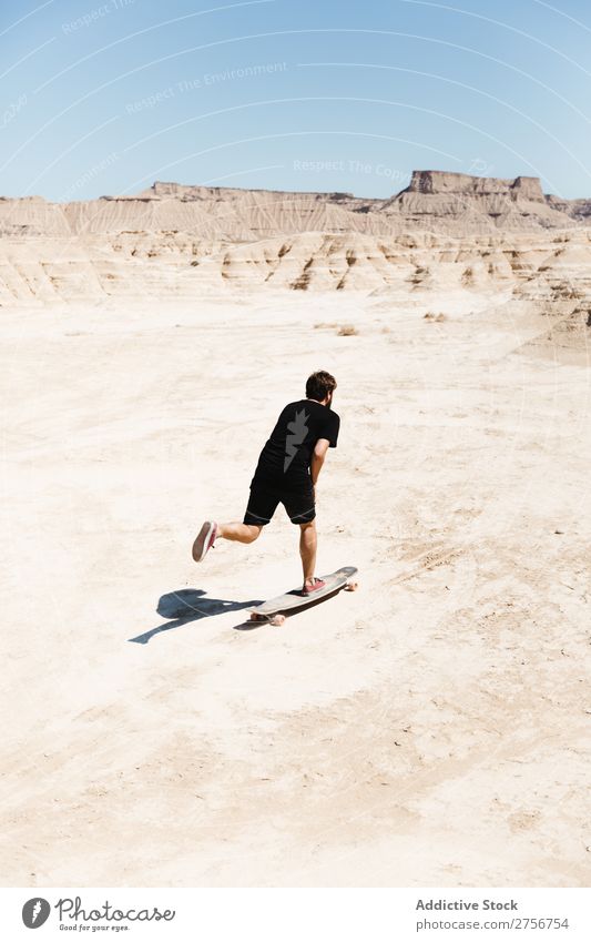 Man riding skateboard in desert Skateboard Desert Vacation & Travel Lifestyle Human being Adults Nature Adventure Trip Tourist Sports Action Extreme Cliff Hill