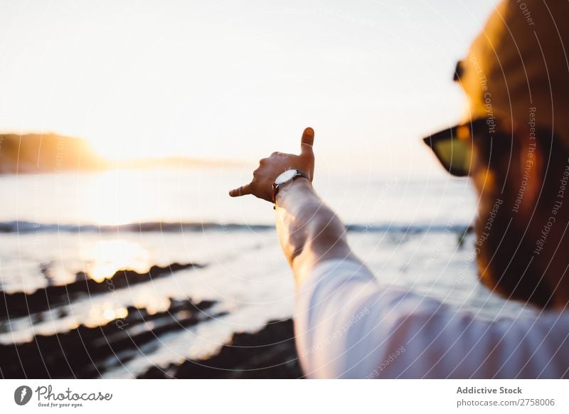 Crop man stretching arm making good gesture Human being Man Hand Ocean Landscape Water Coast Vacation & Travel Nature Summer Sky Rock Island Tourism Sunlight