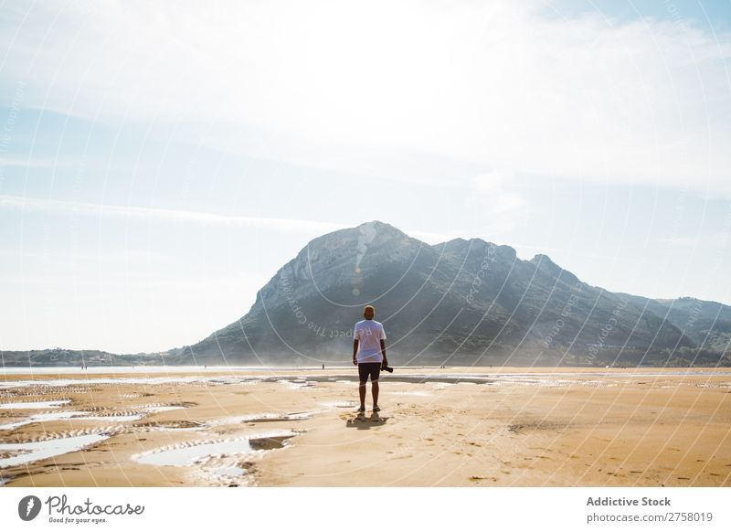 Man standing on beach Sand Beach Wet Summer Ocean Vacation & Travel Nature Human being Sunlight Leisure and hobbies Relaxation Tropical seaside Sunbeam Tourist