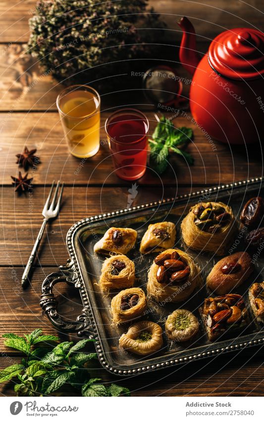 Delicious syrian pastry with tea on a wooden table Above arabic Breakfast Brown bulbul Cooking Dessert Dish Drinking Food Fork Glass Gourmet indoor Kettle