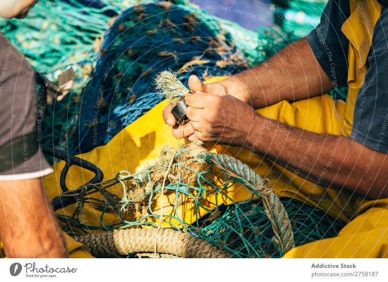 Man working with fishing net Ball bobber Buoy Colour Multicoloured Day Detail Equipment fisher Fishery fishnet Float in the water floats Horizontal Industrial
