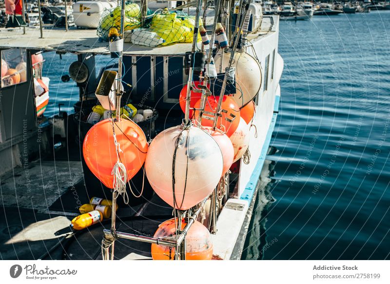 A boat with different floats Blue Watercraft bobber Buoy Calm Colour Multicoloured Equipment Europe Fishery Float in the water Harbour Horizontal Industrial