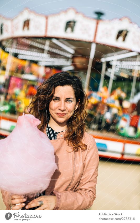 Woman with cotton candy in the park Park Cotton candy Merry-go-round Human being Pink pretty Sweet Food To feed Sugar Joy Lifestyle Portrait photograph
