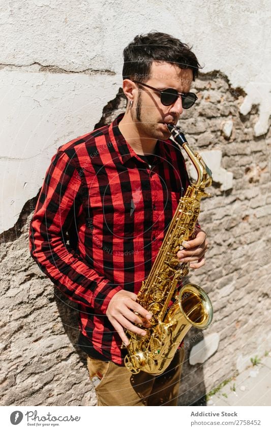 Smiling jazzman with sax Musician Man Sunglasses Self-confident Cool (slang) Cheerful Wall (building) Youth (Young adults) Jazz Saxophone instrument Musical