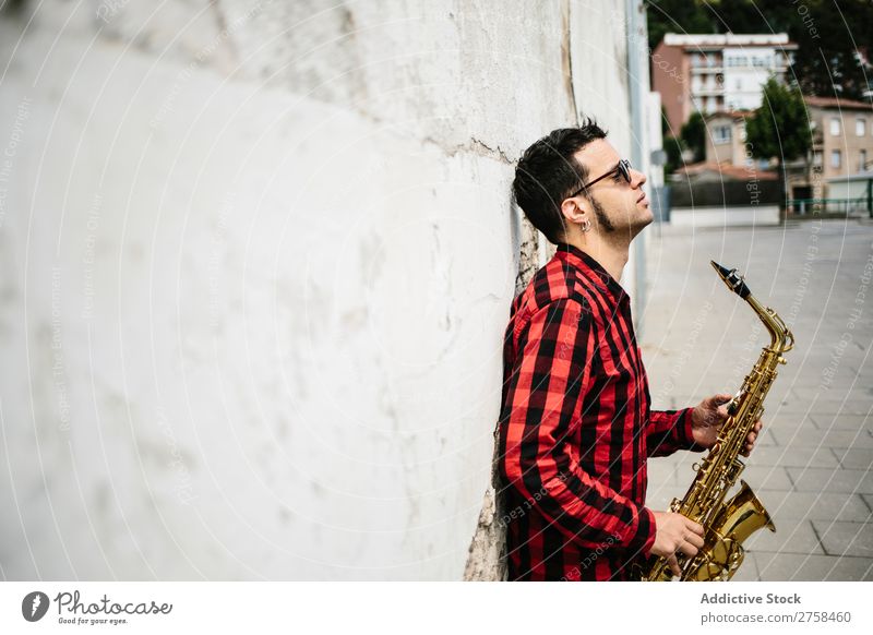 Smiling jazzman with sax Musician Man Sunglasses Self-confident Cool (slang) Cheerful Wall (building) Youth (Young adults) Jazz Saxophone instrument Musical