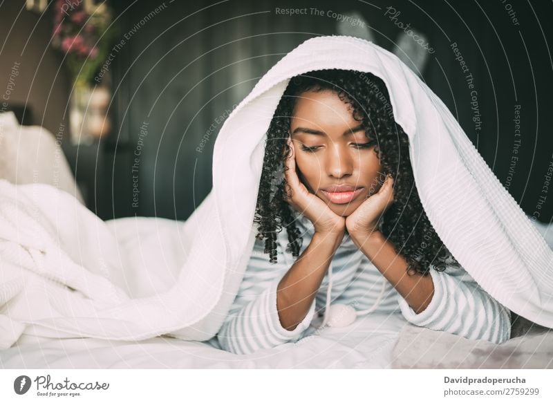 Beautiful serious thoughtful and sad black woman covering her head with sheet in bed Woman Bed Sadness Anger Black worried trouble problems Covered Covering