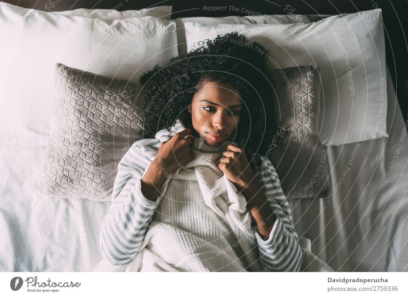 Beautiful Thoughtful Black Woman With Curly Hair Lying On Bed Looking