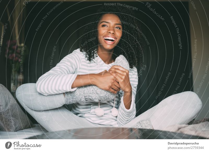 close up of a pretty black woman with curly hair smiling and lying on bed looking away Woman Bed Portrait photograph Close-up Lie (Untruth) Black Smiling