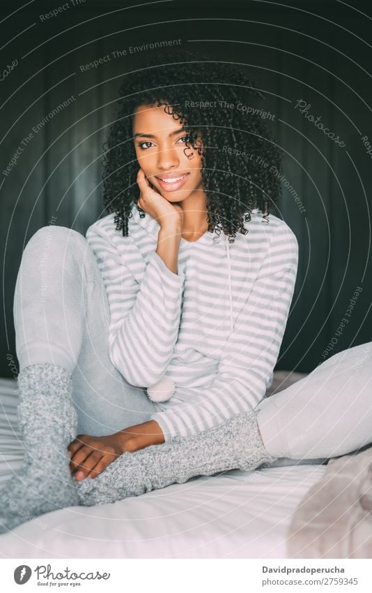 close up of a pretty black woman with curly hair smiling sit on bed looking at the camera Woman Bed Portrait photograph Close-up Sit Black Smiling African