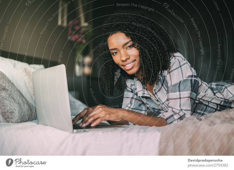 beautiful black woman on bed with laptop and cup of coffee Woman Bed Notebook Computer Smiling Portrait photograph Close-up Technology Internet wifi device