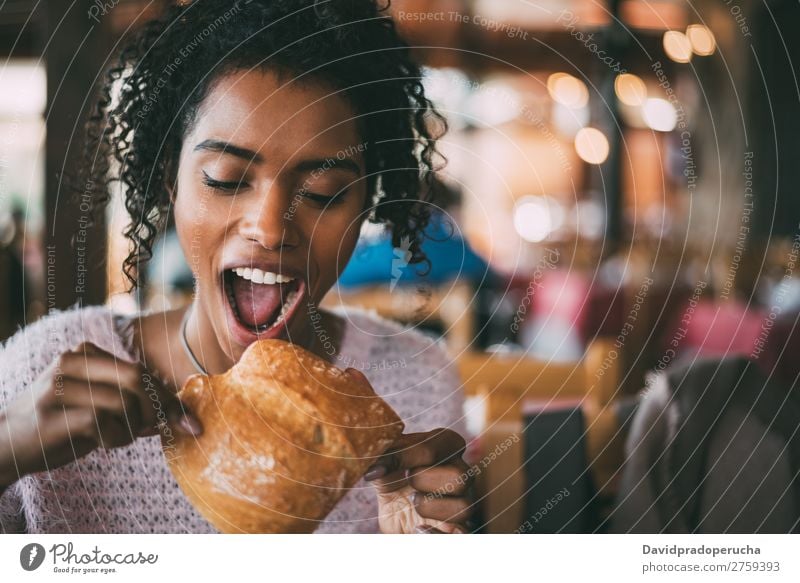Black woman eating bread Woman Eating Food Ethnic African Mixed race ethnicity Restaurant Bread Meal To feed Lunch Copy Space Horizontal Lifestyle Cute Happy