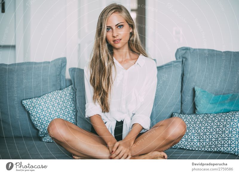 Portrait of a young thoughtful blonde woman sitting in the sofa Woman Sit Sofa Couch Portrait photograph Room Smiling Youth (Young adults) Considerate pretty