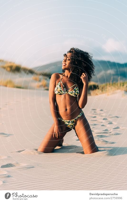 Beautiful young woman posing on the sand in the beach Beach Sand pose Woman Human being Isolated romantic Ocean Sun Vacation & Travel Nature Swimming Suit Joy