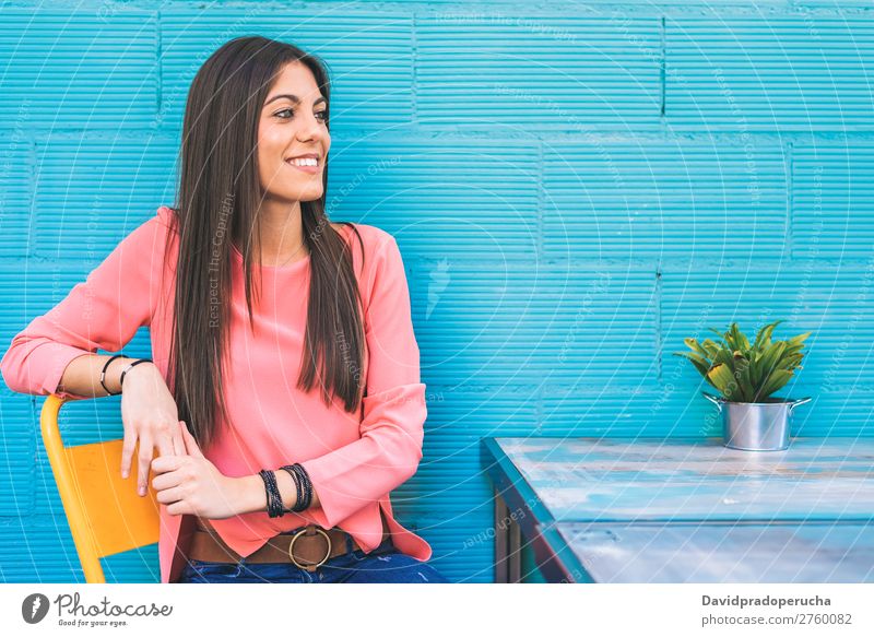Happy young woman seating in a restaurant Adults Loneliness Attractive Beautiful Blue Bright brunet Caucasian Coffee Café Multicoloured enjoying Woman Food